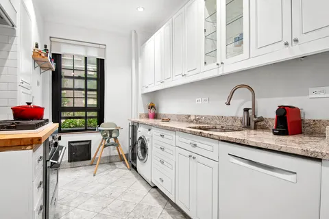 a kitchen with stainless steel appliances granite countertop a sink and cabinets