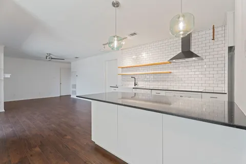 a kitchen with stainless steel appliances a sink and a refrigerator