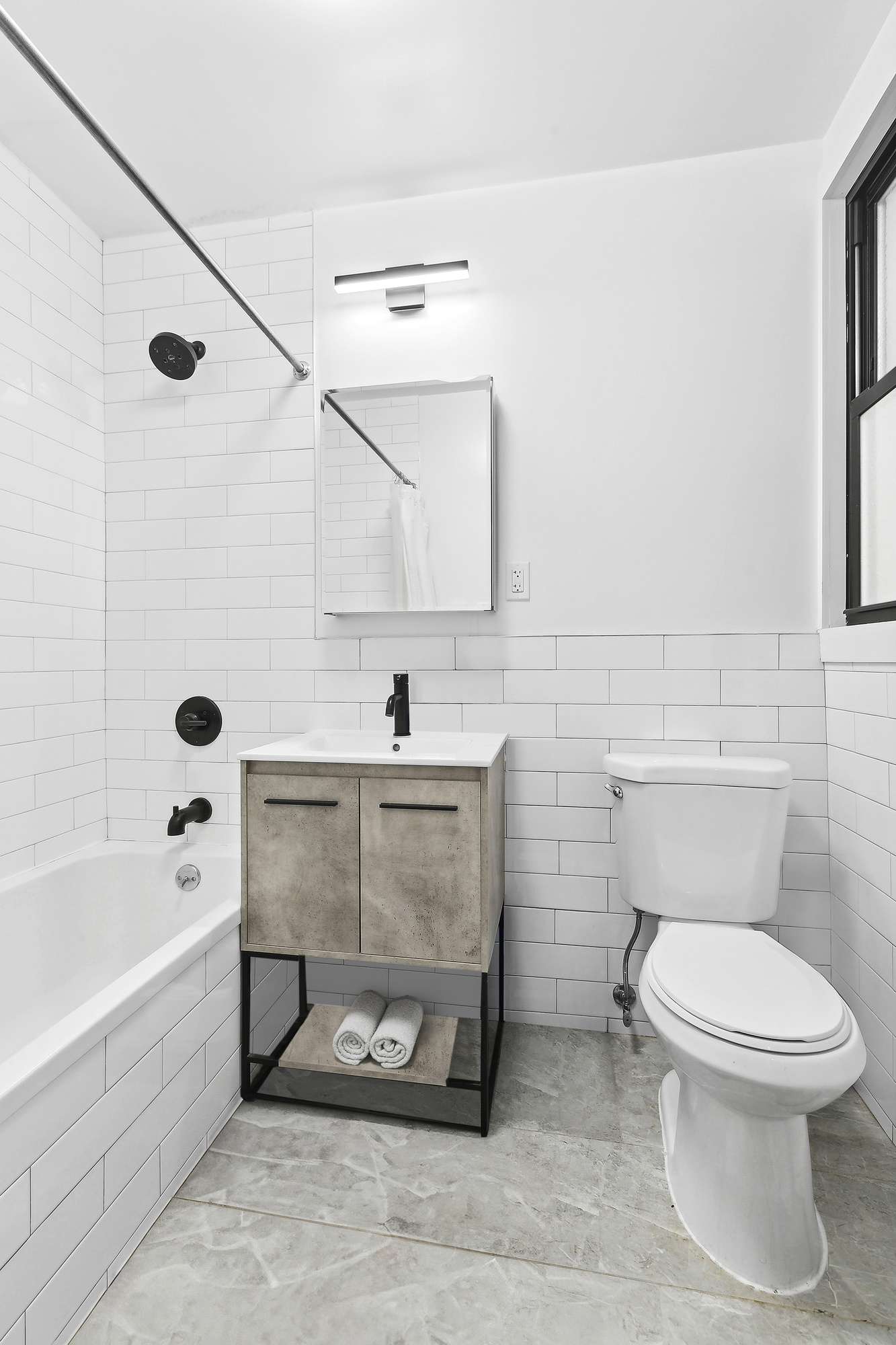 82 7th Avenue, Unit 4 Brooklyn, NY 11217 - Photo 5 of 10 a bathroom with a toilet a sink and bathtub
