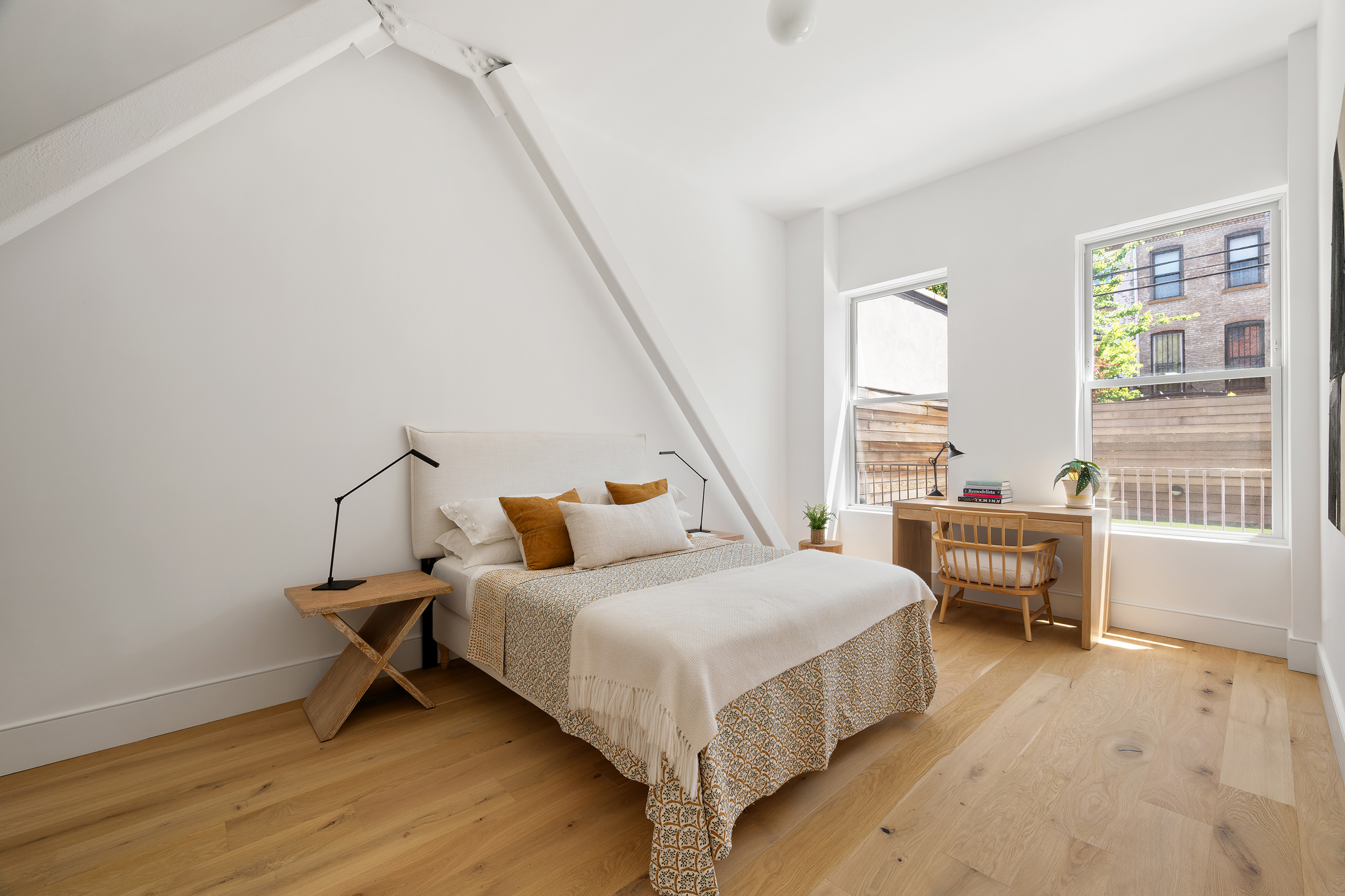 524 Halsey Street, Unit 109 Brooklyn, NY 11233 - Photo 3 of 10 a bedroom with a bed and a table in it