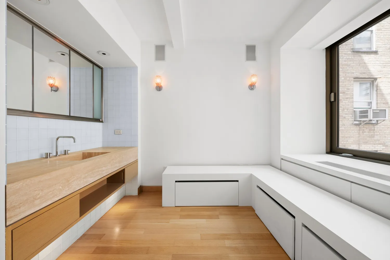 a bathroom with a tub sink and mirror