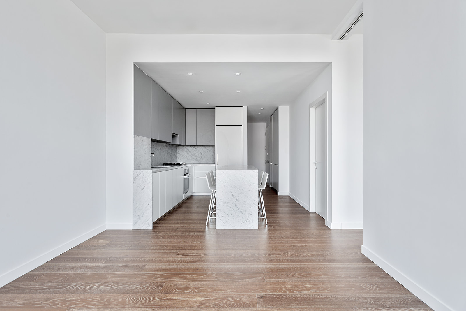 287 East Houston Street, Unit 5B Manhattan, NY 10002 - Photo 3 of 7 a view of kitchen with furniture and wooden floor