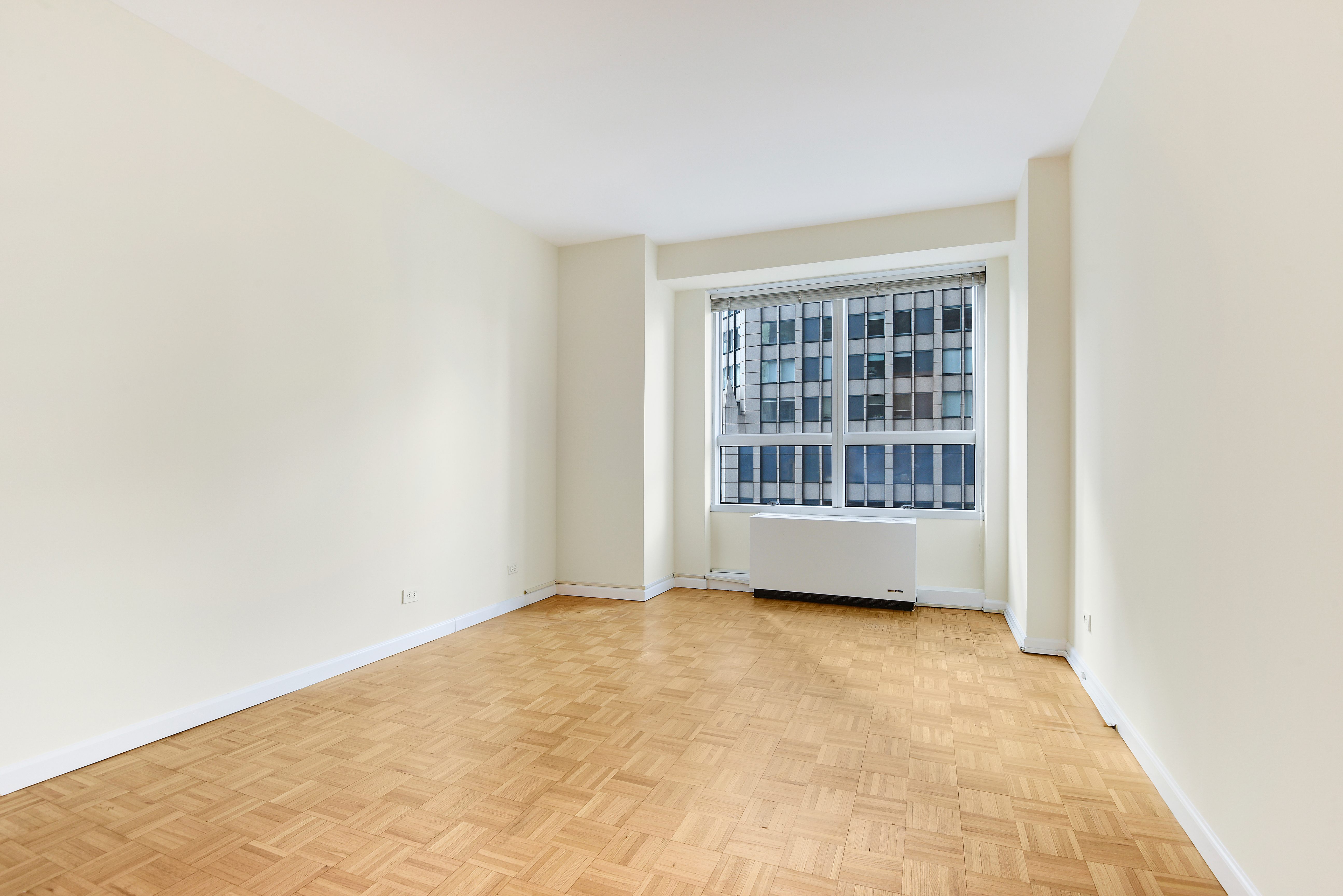 146 West 57th Street, Unit 38E Manhattan, NY 10019 - Photo 12 of 16 a view of an empty room with a window