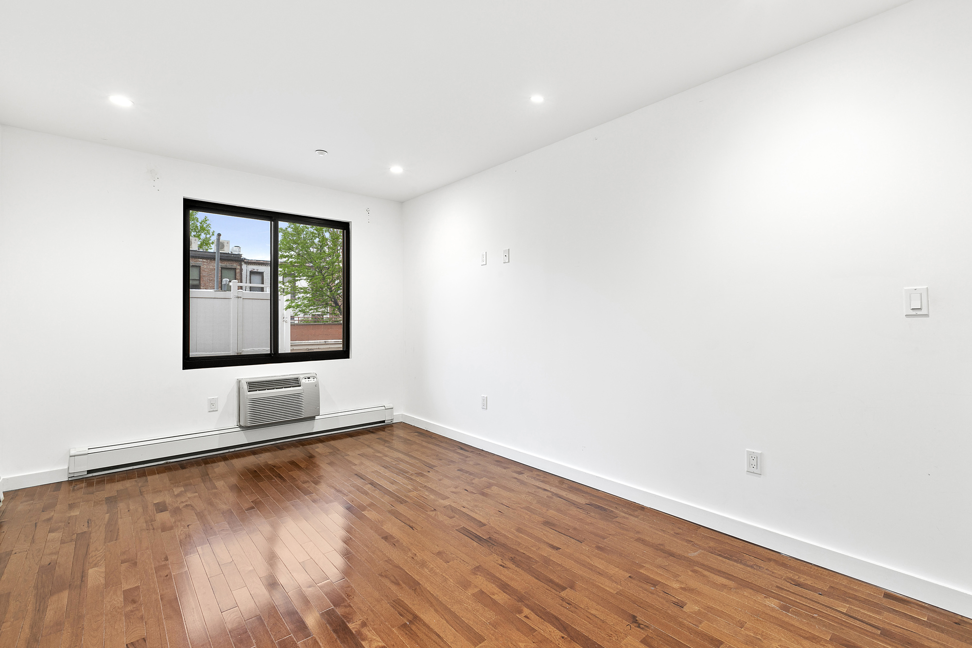 400 15th Street, Unit 2D Brooklyn, NY 11215 - Photo 5 of 8 an empty room with wooden floor and windows
