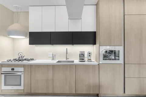 a kitchen with a sink and cabinets