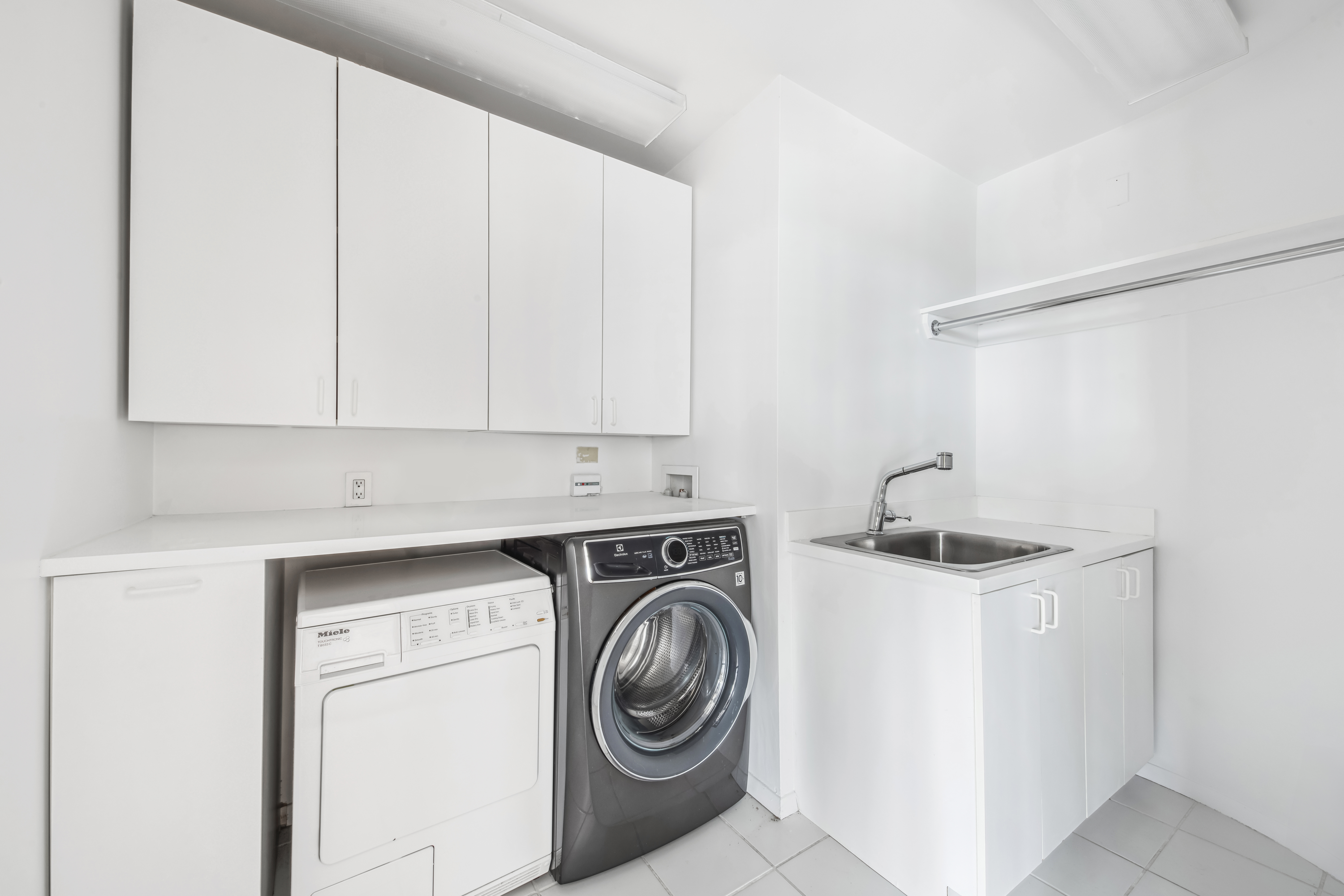 870 United Nations Plaza, Unit 15E Manhattan, NY 10017 - Photo 17 of 19 a view of storage and utility room with washer and dryer