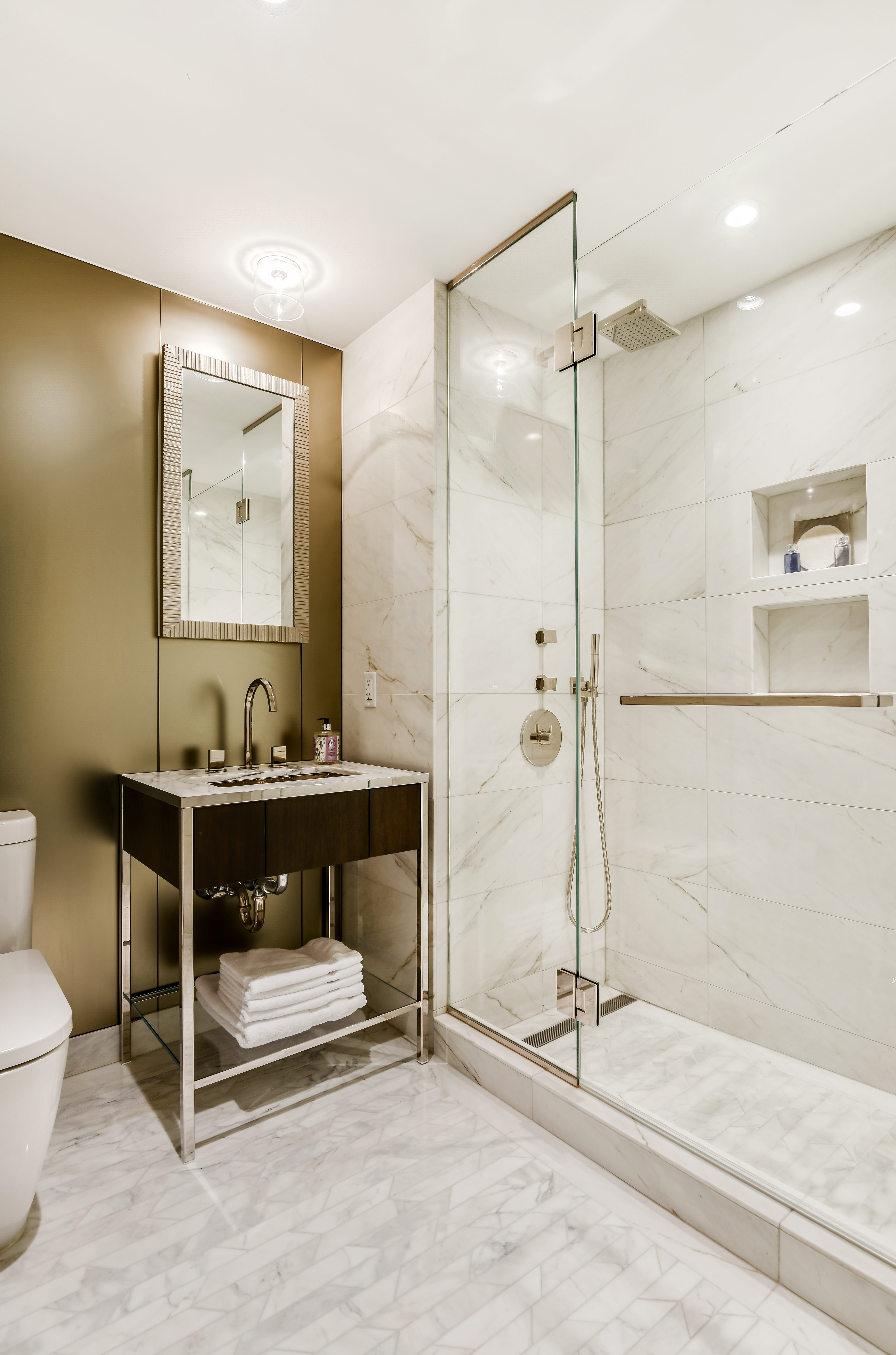 135 West 52nd Street, Unit 23C Manhattan, NY 10019 - Photo 13 of 19 a bathroom with a sink and a mirror
