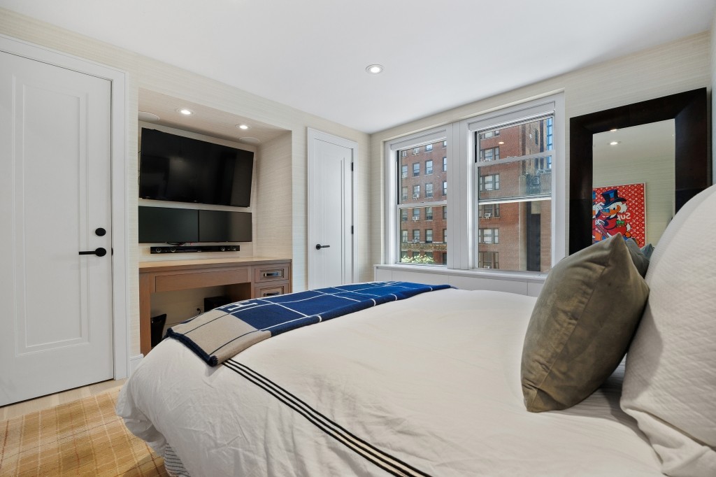 433 West 34th Street, Unit 4ABC Manhattan, NY 10001 - Photo 11 of 20 a bedroom with a large bed and a flat screen tv