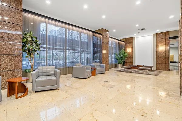185 West End Avenue, Unit 11P Manhattan, NY 10023 - Photo 7 of 10 a lobby with a couch and potted plant in front of it
