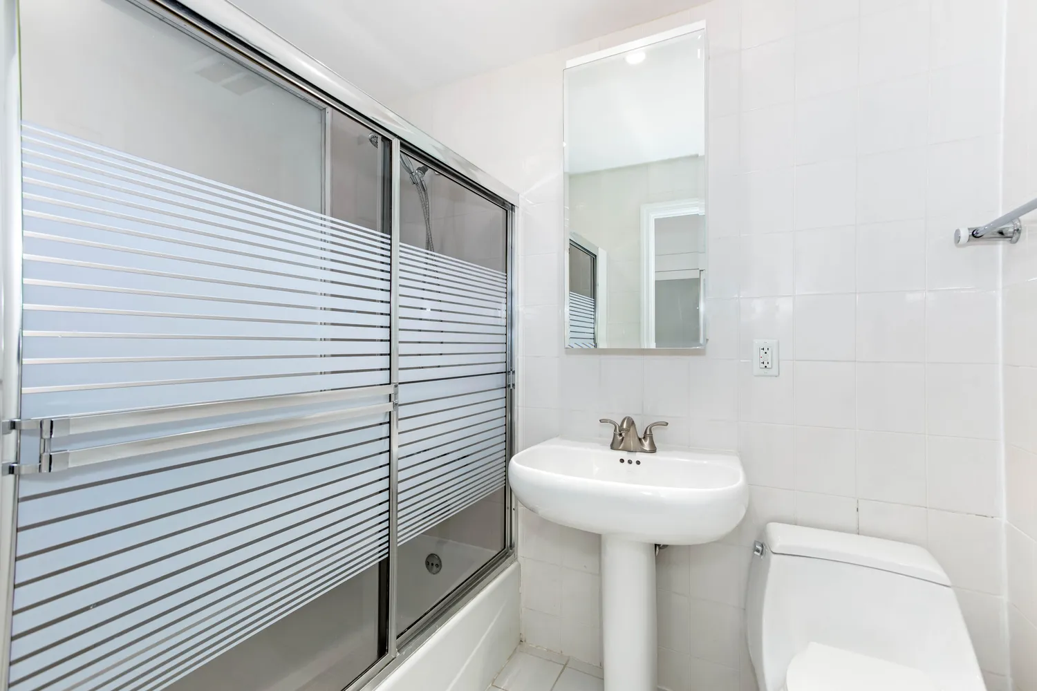 a bathroom with a sink a mirror and a toilet