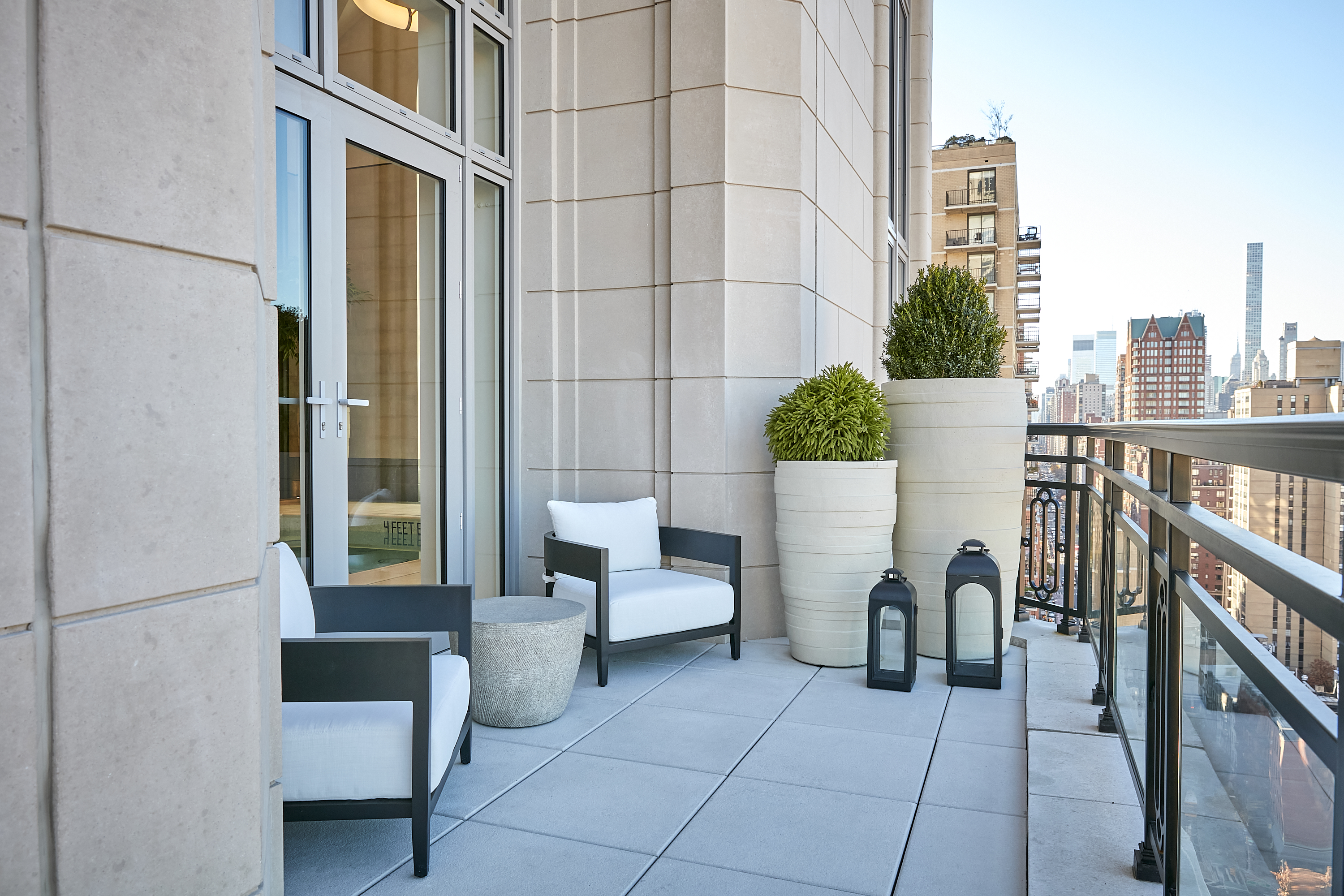 200 East 83rd Street, Unit 34A Manhattan, NY 10028 - Photo 31 of 34 a view of a patio with couches and a potted plant on a table