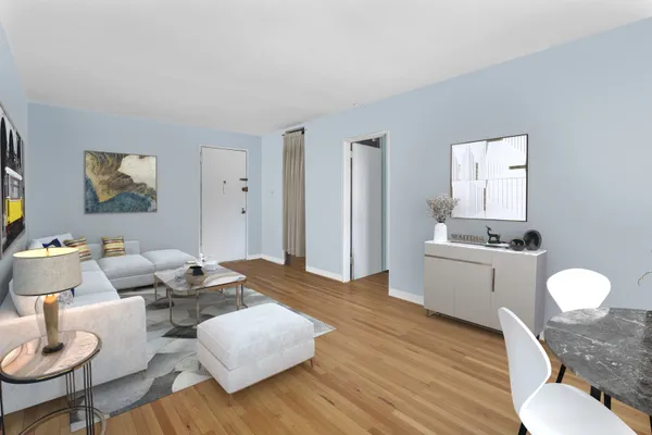 a living room with furniture and wooden floor