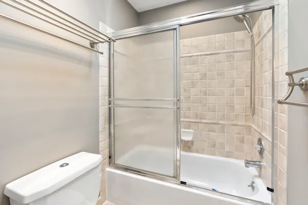 a bathroom with a granite countertop sink a mirror and a shower