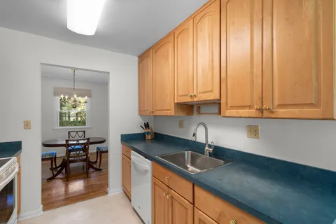 a kitchen with stainless steel appliances granite countertop a sink a stove and a wooden floors