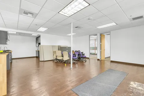 a view of a livingroom with wooden floor and a cabinet