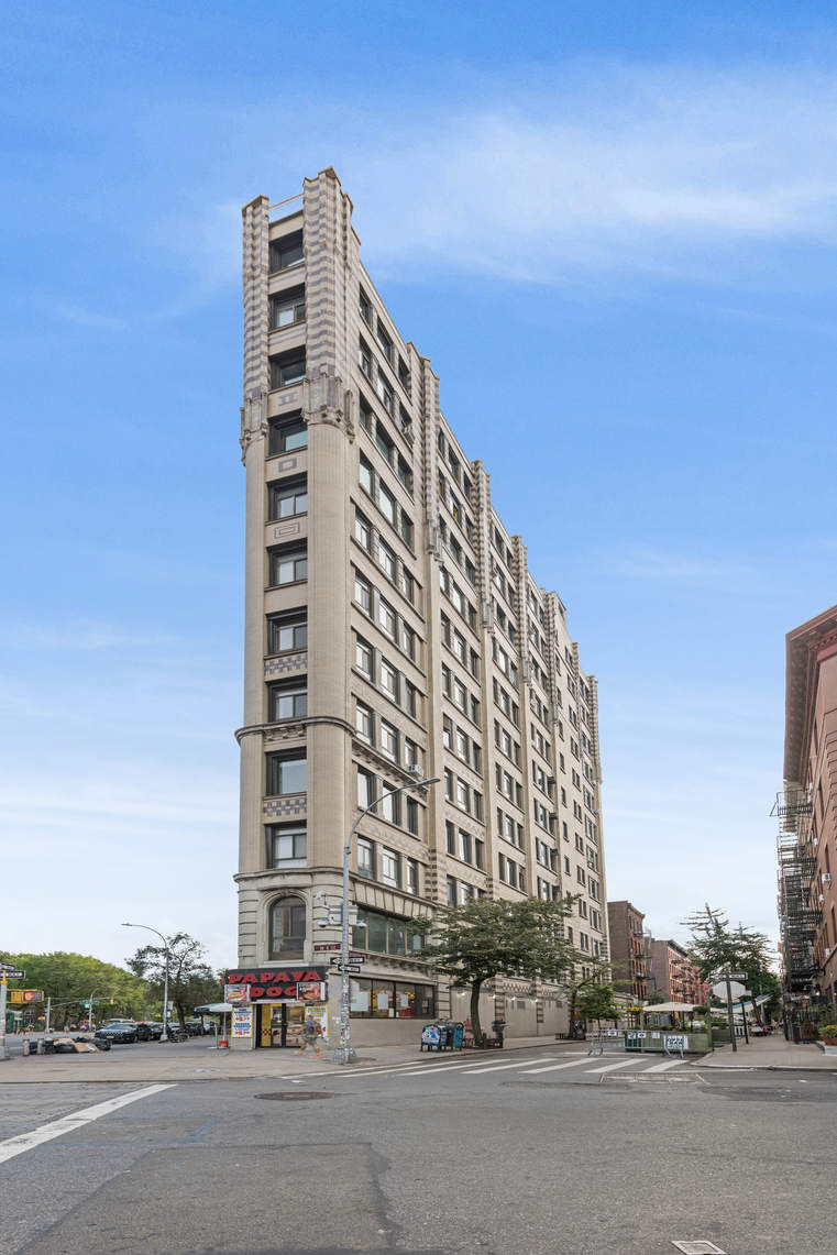 2 Cornelia Street, Unit 201 Manhattan, NY 10014 - Photo 10 of 11 a city street with tall buildings in the background