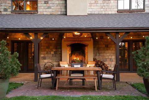a view of a patio with table and chairs with wooden floor and plants