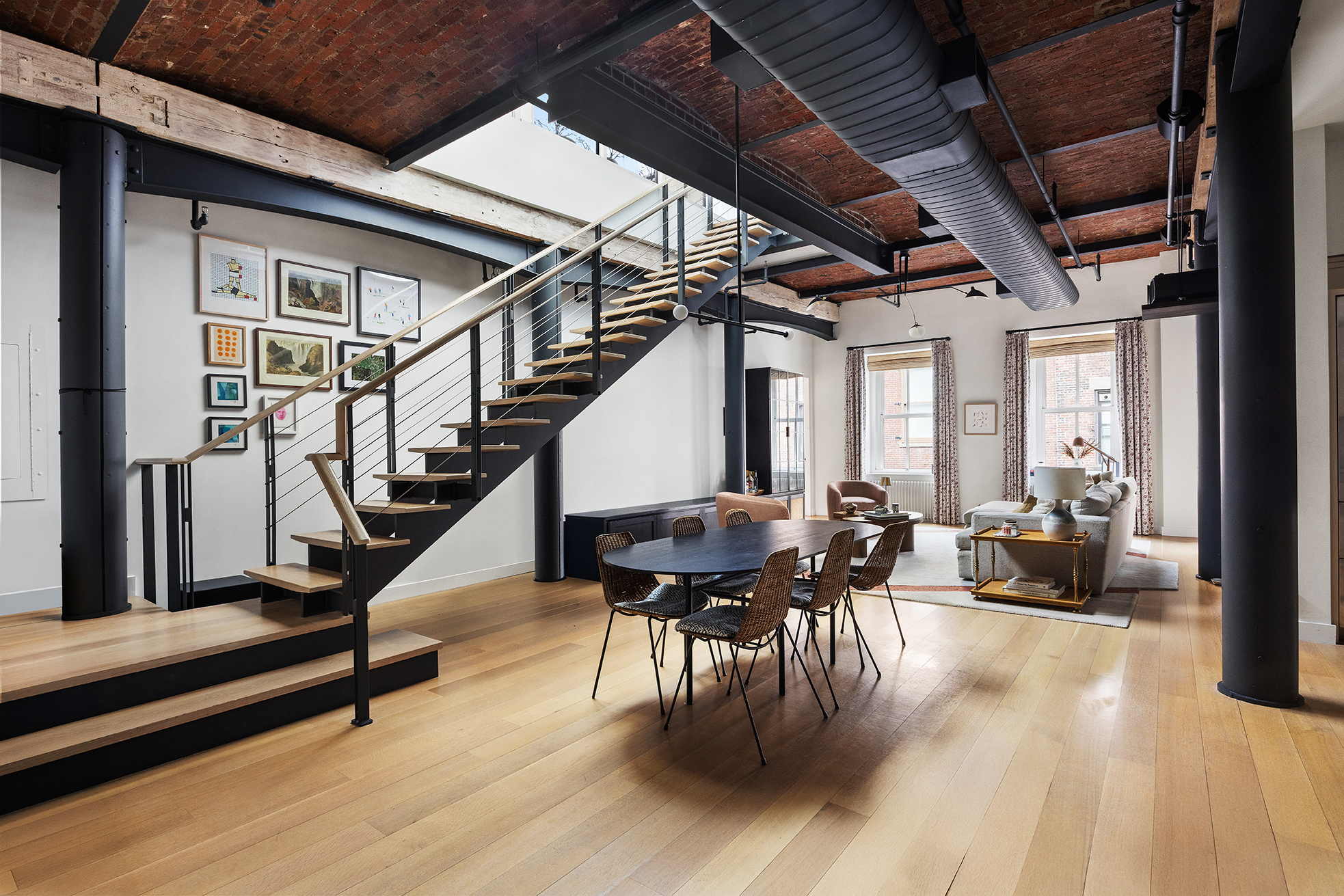 a dining room with wooden floor table and chairs