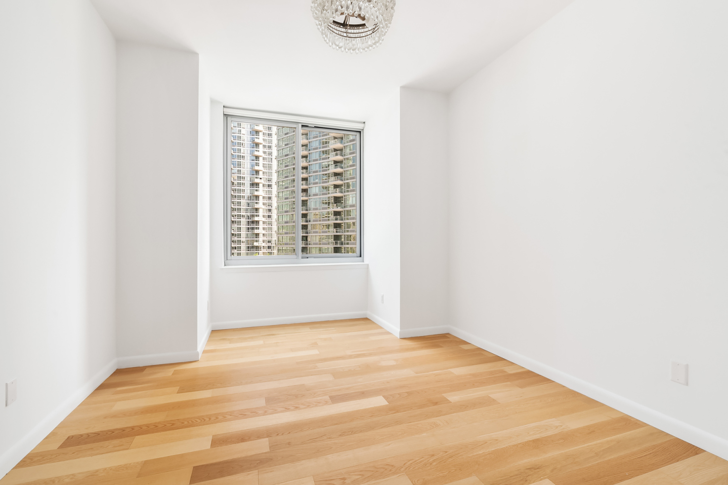 46-30 Center Boulevard, Unit 1102 Queens, NY 11109 - Photo 7 of 26 a view of an empty room with a window