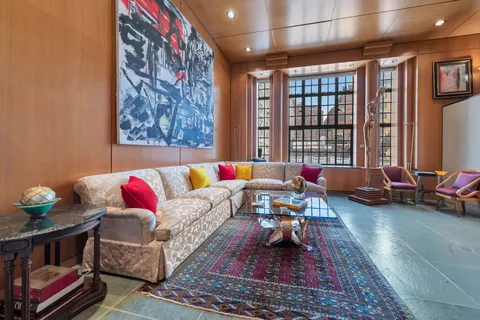 a living room with furniture rug and window