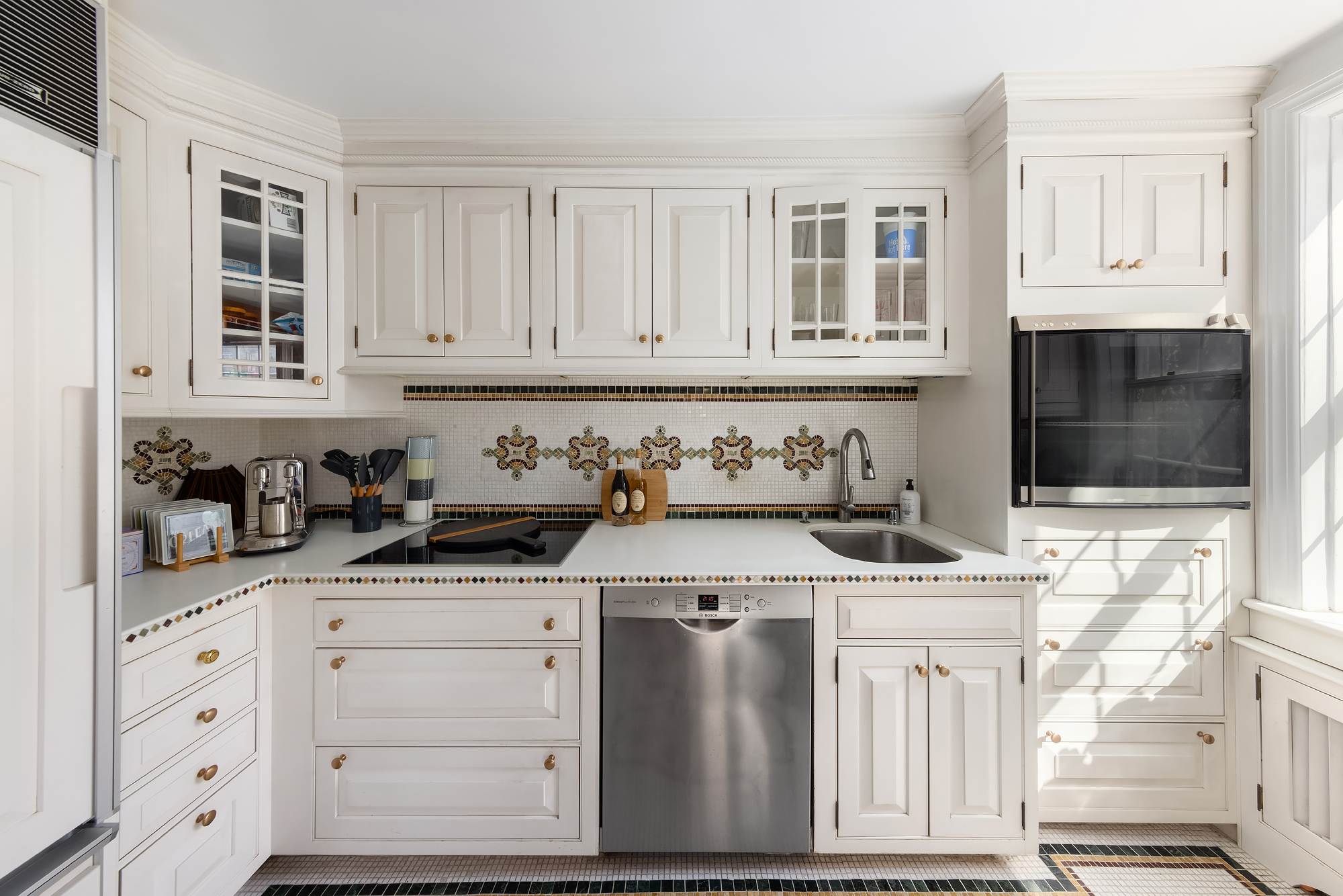 159 West 13th Street Manhattan, NY 10011 - Photo 33 of 36 a kitchen with stainless steel appliances granite countertop a stove a sink and white cabinets