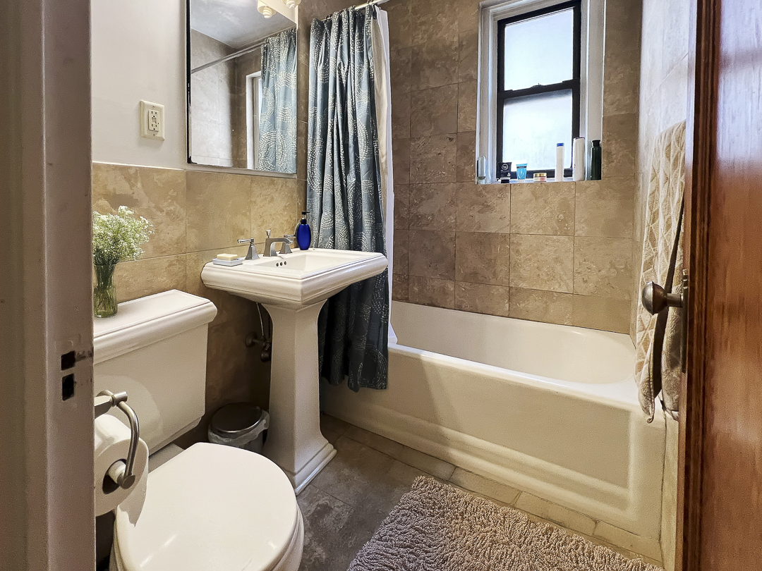 208 East 28th Street, Unit 4A Manhattan, NY 10016 - Photo 7 of 12 a bathroom with a sink a toilet and bathtub