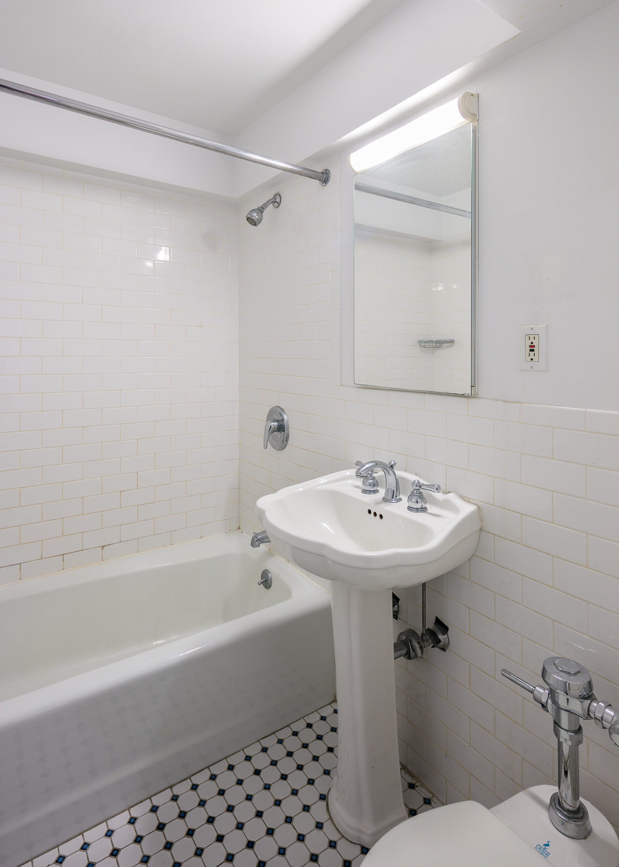 335 East 51st Street, Unit 2D Manhattan, NY 10022 - Photo 8 of 11 a bathroom with a sink a toilet and shower
