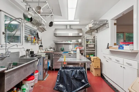 a room with lots of wooden furniture and a chandelier