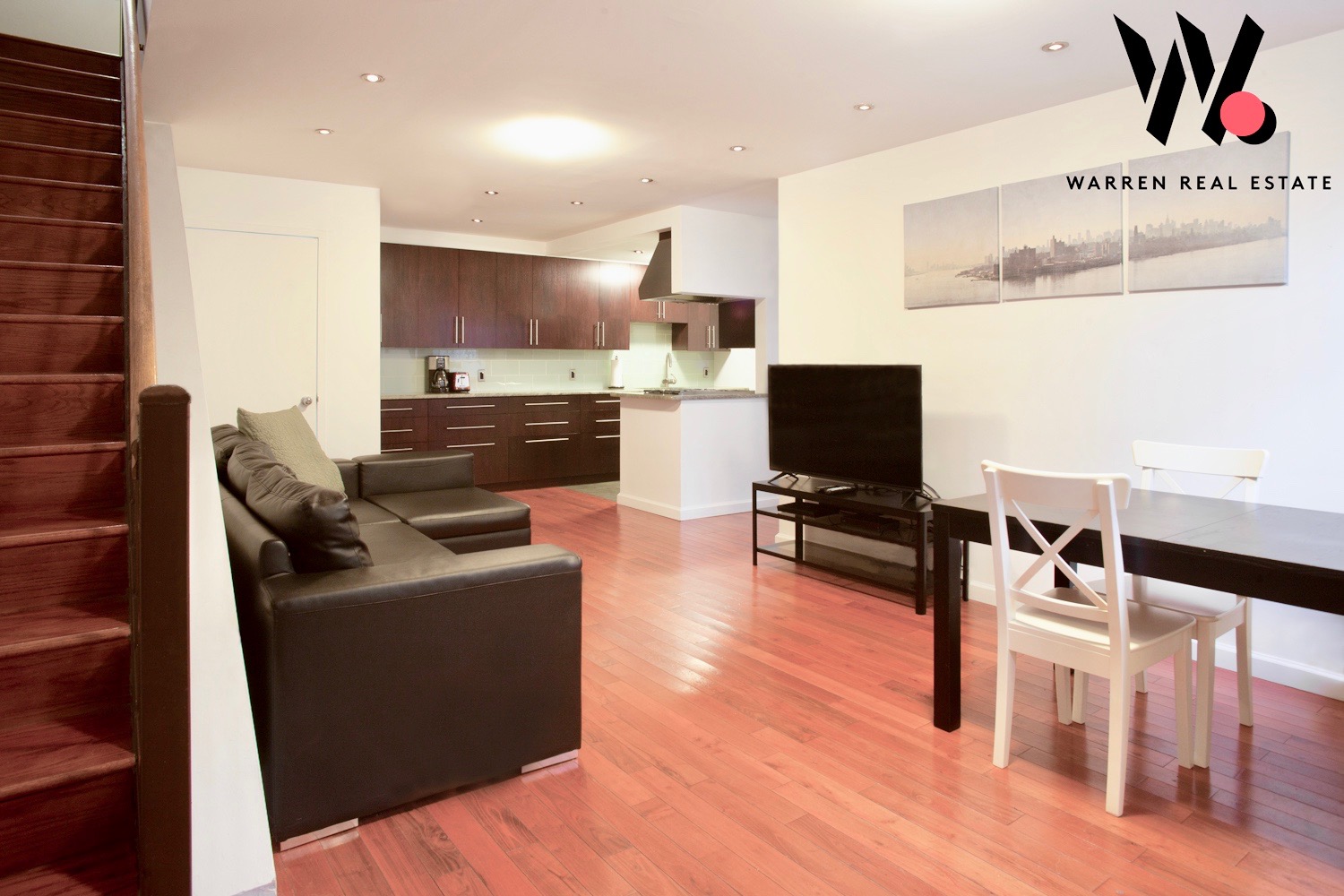 153 Stanton Street, Unit A1 Manhattan, NY 10002 - Photo 9 of 16 a living room with furniture and a flat screen tv
