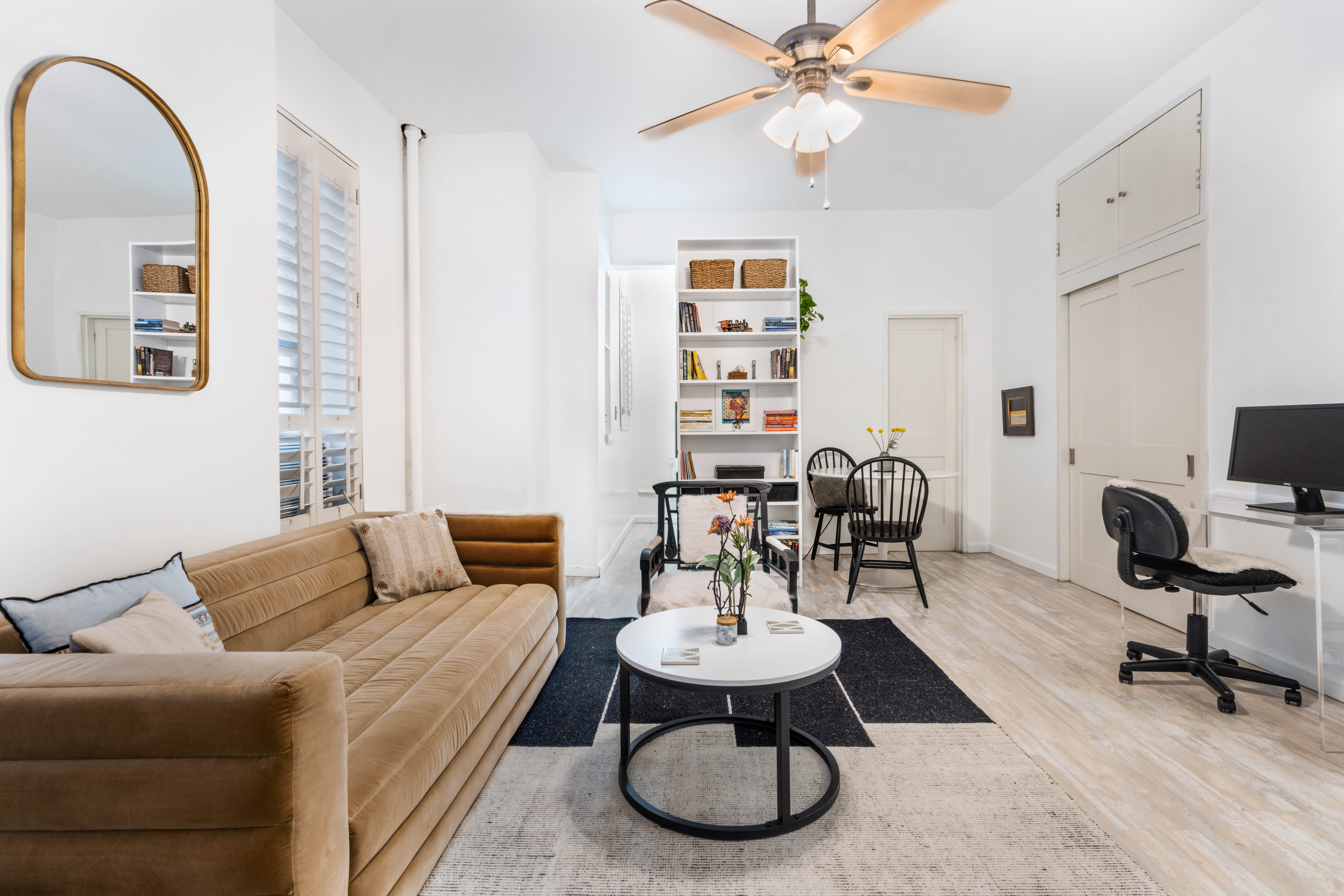 a living room with furniture a table and chair