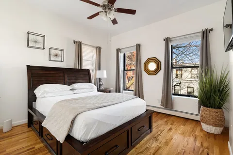 a bedroom with a large bed and a window