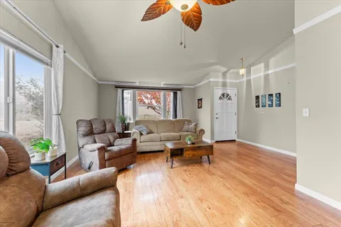 a living room with furniture and wooden floor