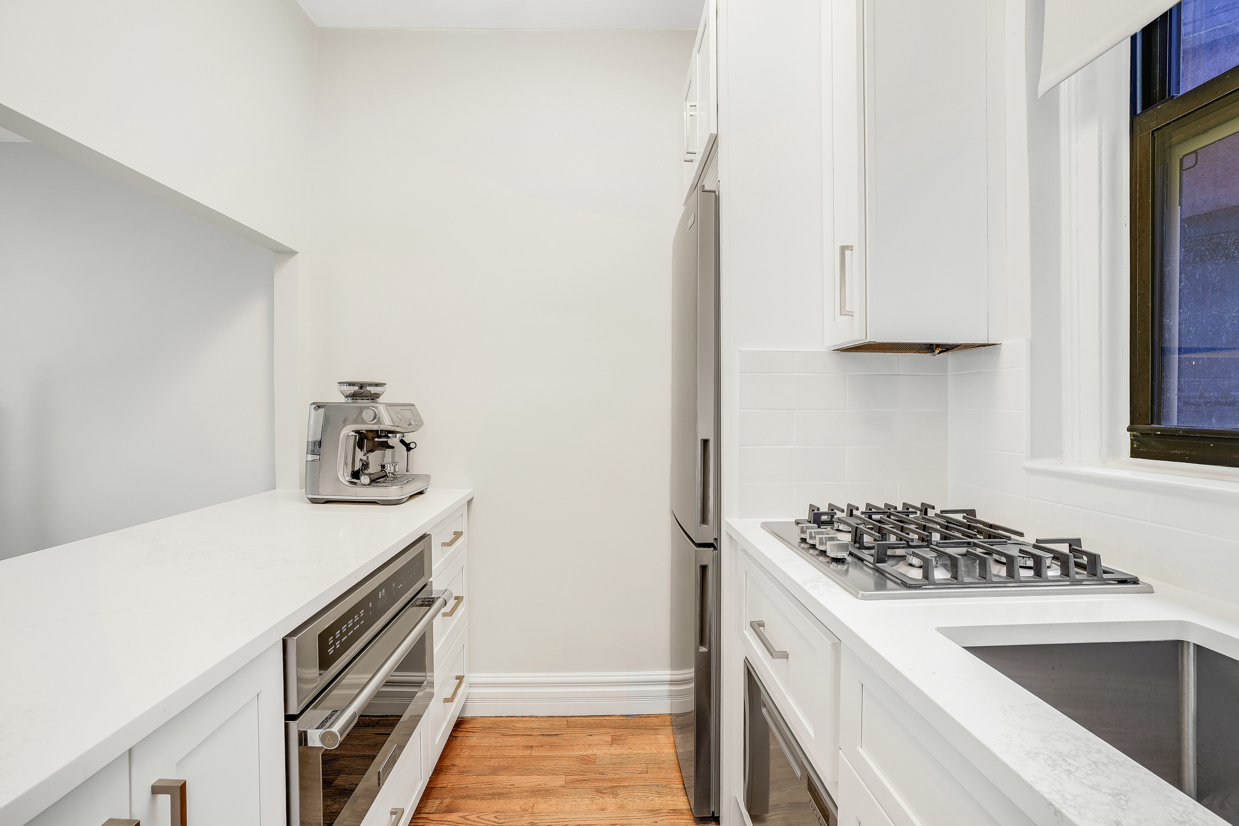 129 West 89th Street, Unit 36 Manhattan, NY 10024 - Photo 6 of 14 a kitchen with a stove and a refrigerator