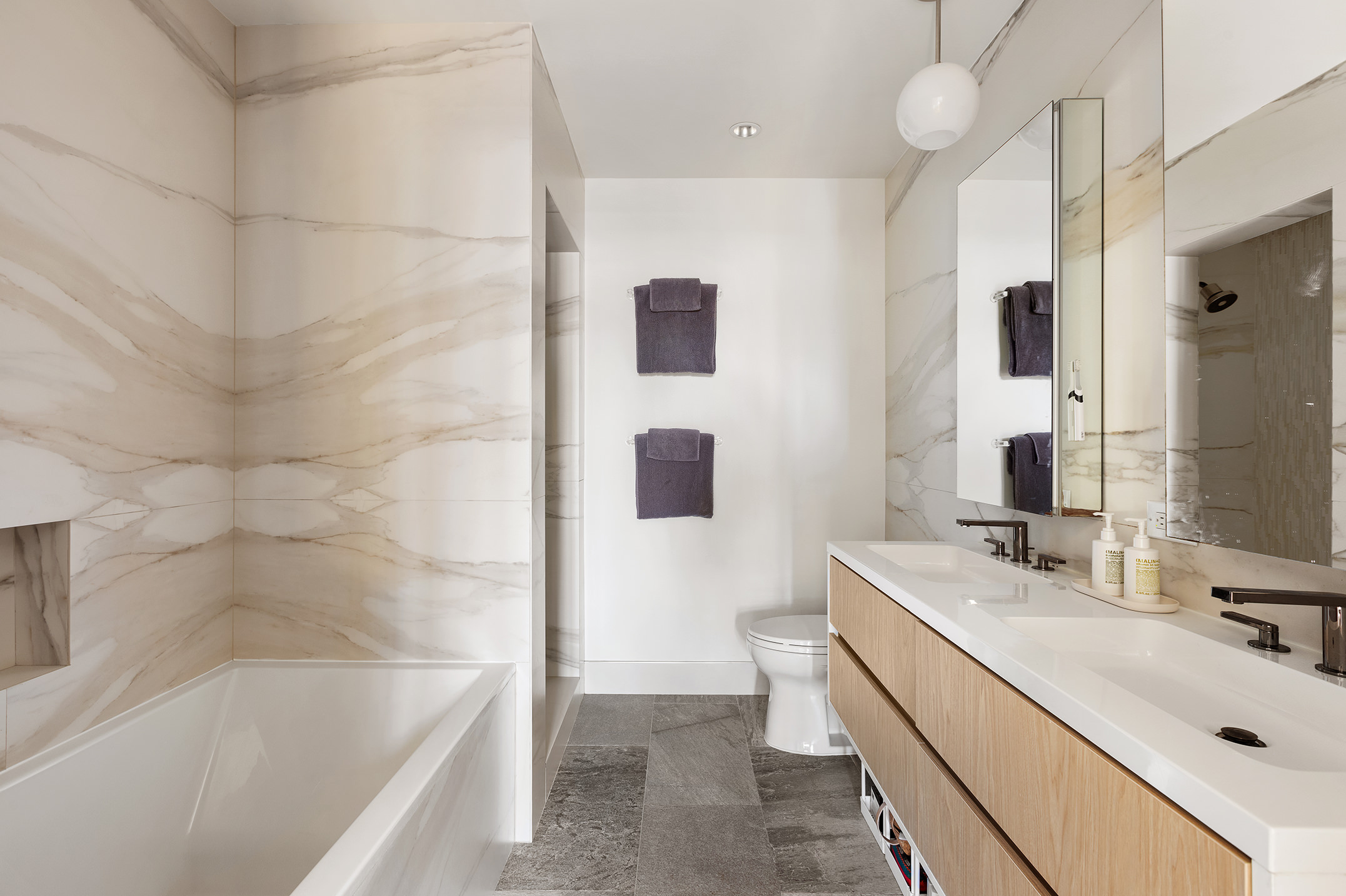 868 Lorimer Street, Unit 4C Brooklyn, NY 11222 - Photo 7 of 14 a bathroom with a tub sink and mirror
