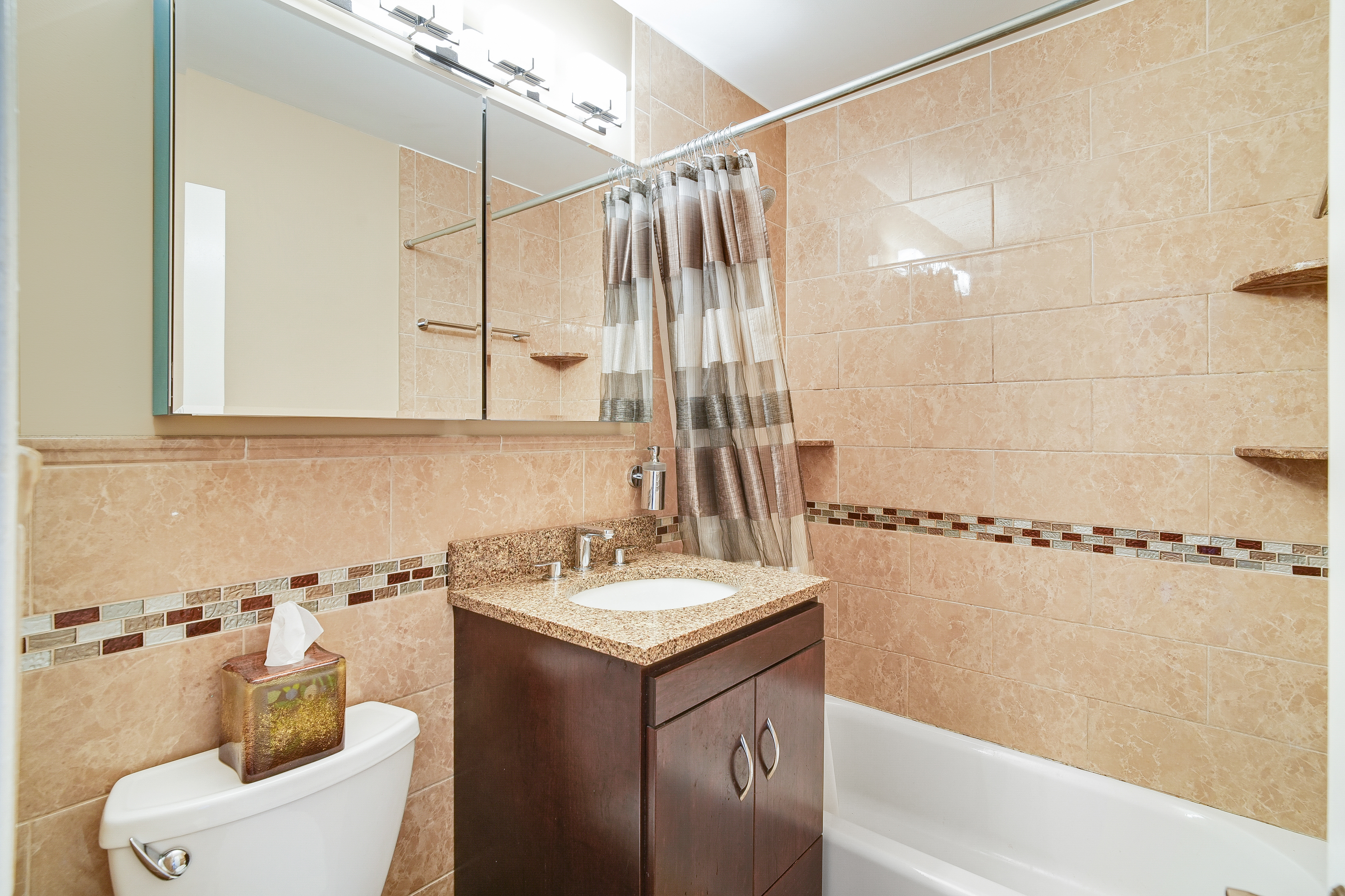 401 East 86th Street, Unit 15C Manhattan, NY 10028 - Photo 8 of 14 a bathroom with a sink a toilet and shower