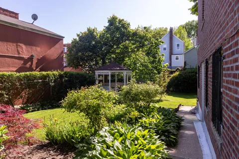 a view of a house with a yard and garden
