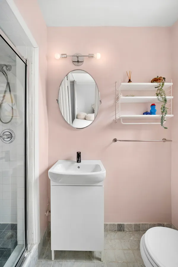 a bathroom with a sink toilet and mirror