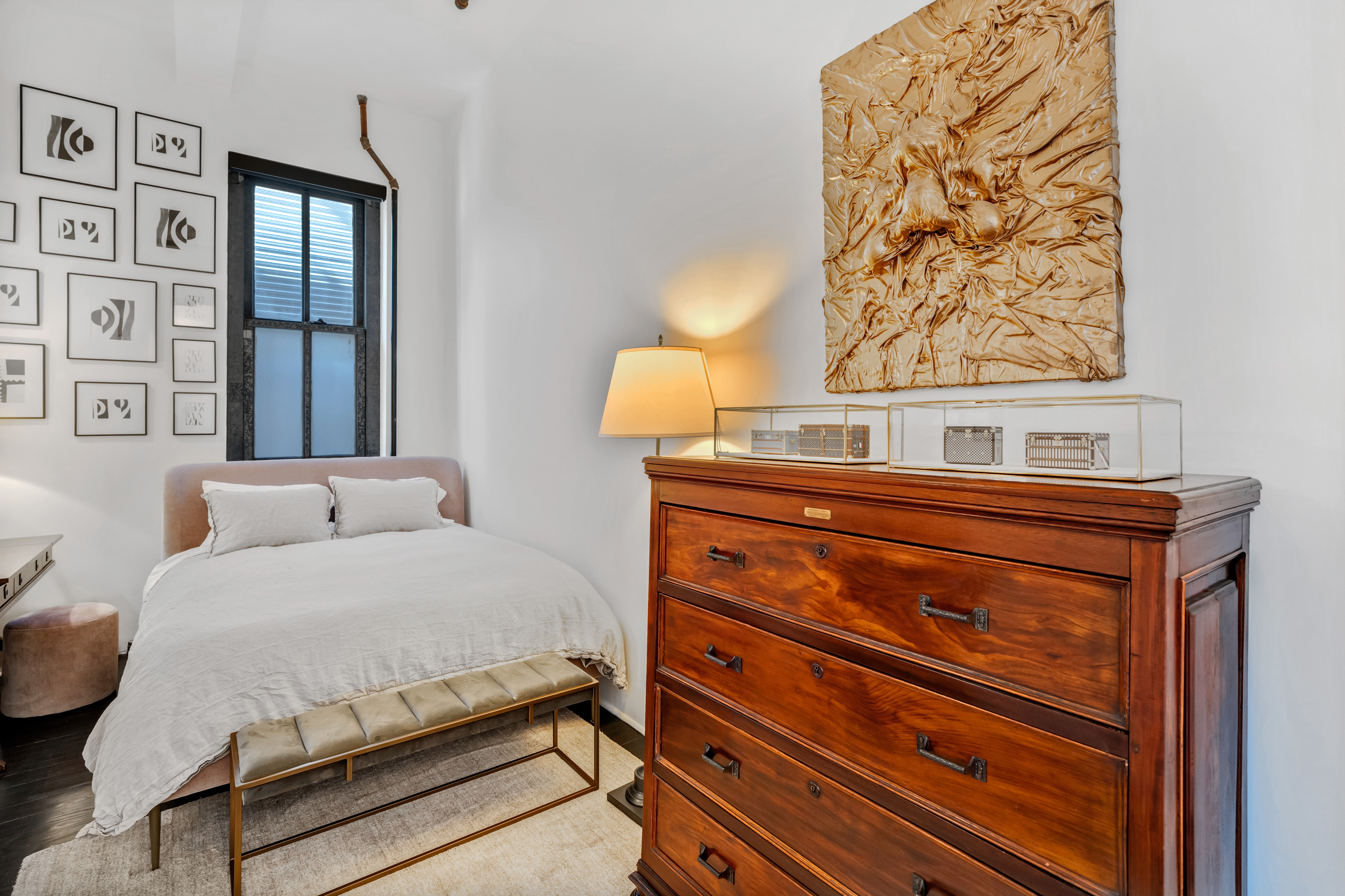 448 West 37th Street, Unit 11G/12G Manhattan, NY 10018 - Photo 15 of 17 a bedroom with a bed and wooden floor