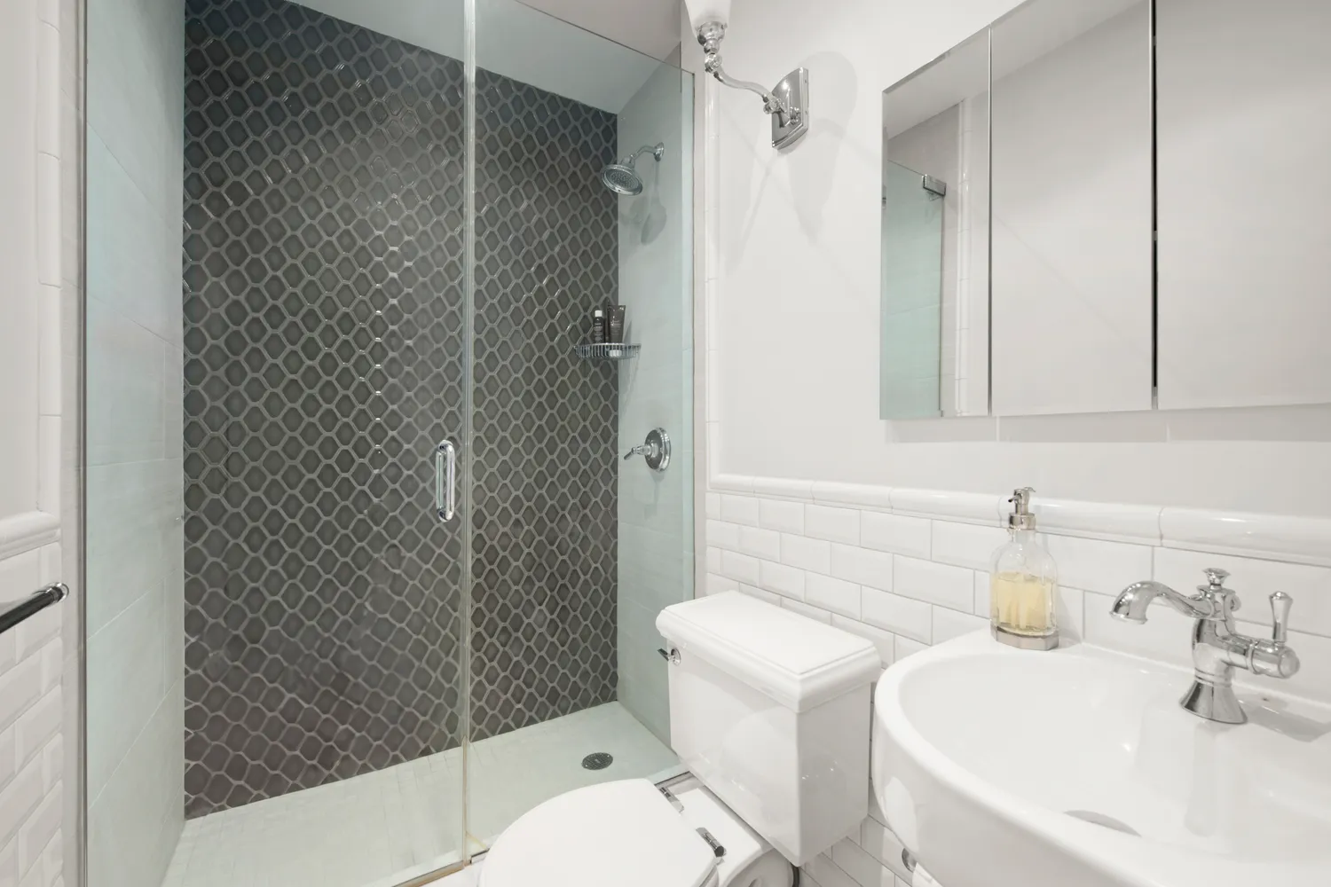 a bathroom with a sink toilet and shower