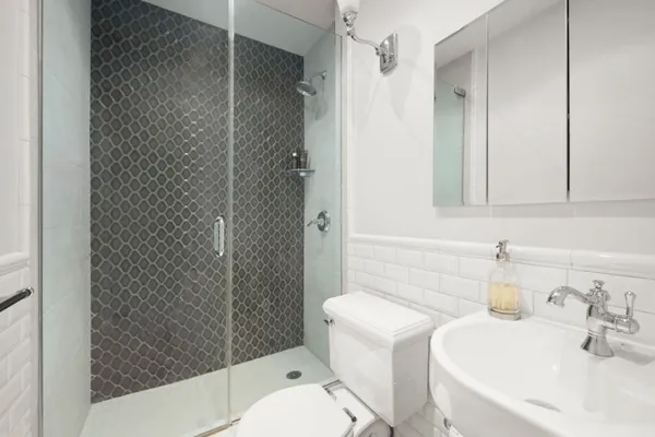 a bathroom with a sink toilet and shower