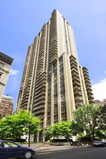 a picture of a bench in front of a white house