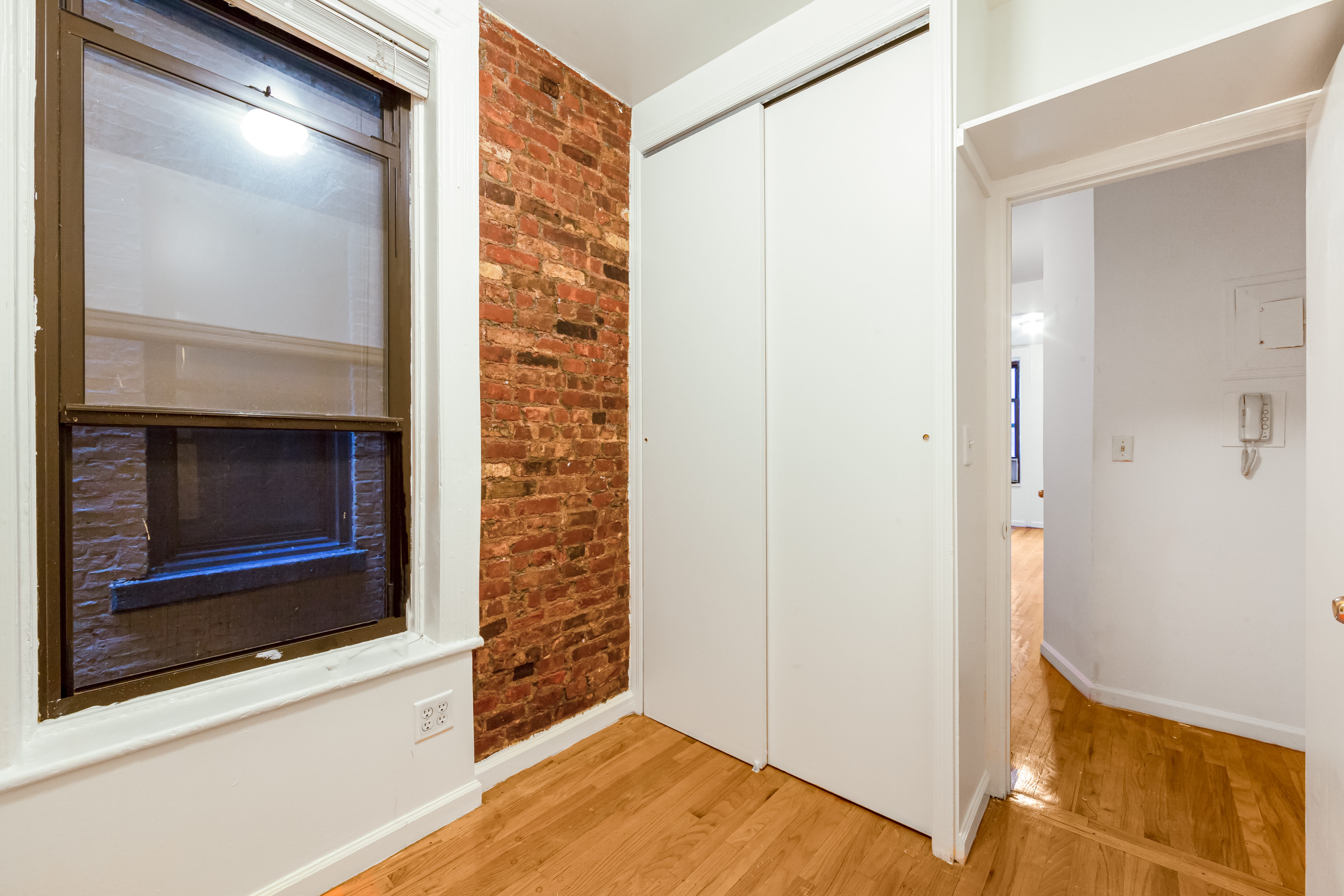 142 Sullivan Street, Unit 12 Manhattan, NY 10012 - Photo 9 of 12 a view of an empty room and wooden floor