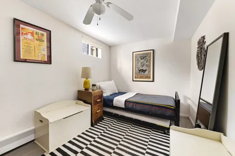 a bedroom with furniture and a window