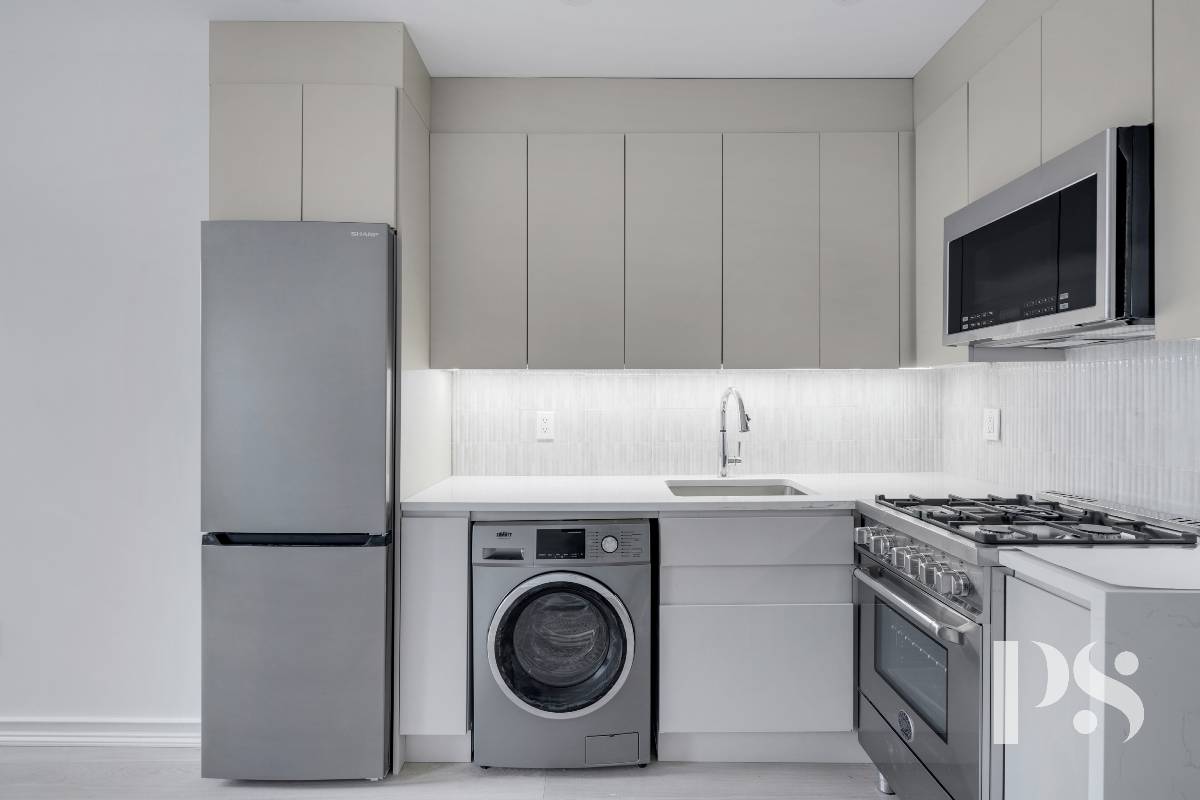 a kitchen with a stove and a microwave