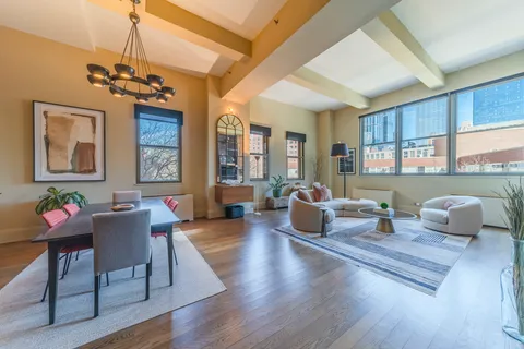 a living room with fireplace furniture and a wooden floor