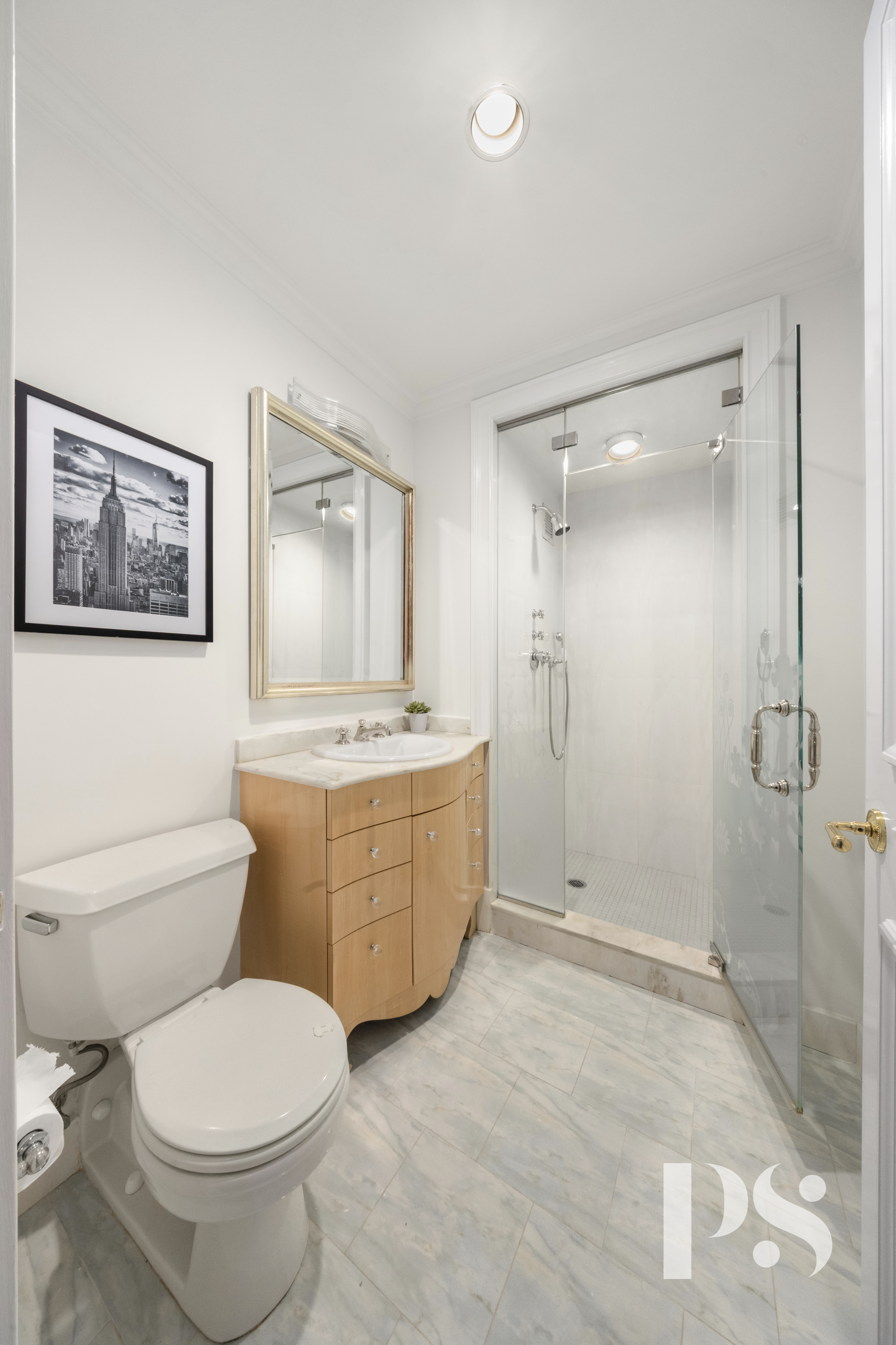 610 Park Avenue, Unit 4B Manhattan, NY 10065 - Photo 17 of 22 a bathroom with a granite countertop toilet a sink and mirror