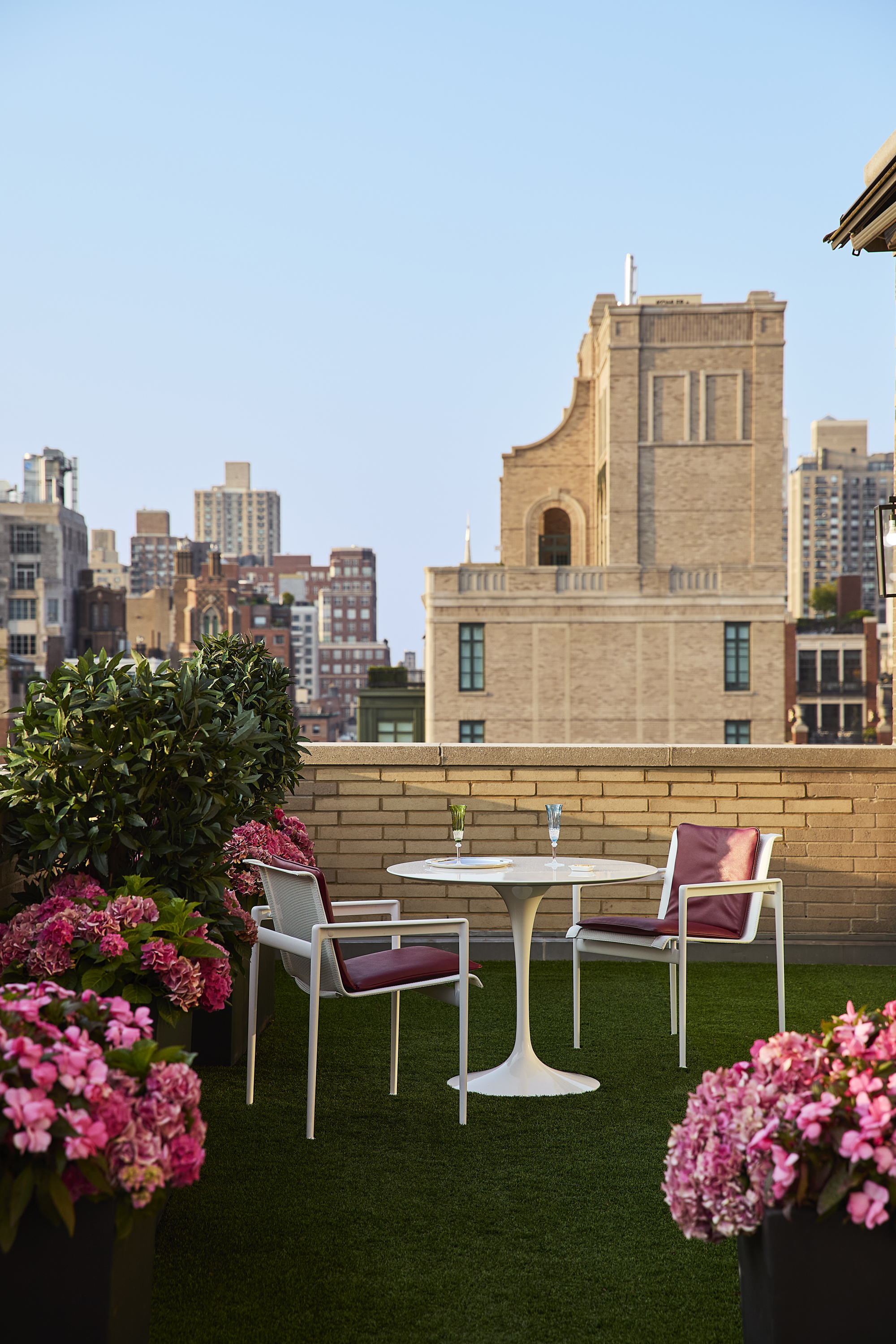 145 East 76th Street, Unit PH Manhattan, NY 10021 - Photo 17 of 25 a view of a house with a big yard and a fountain