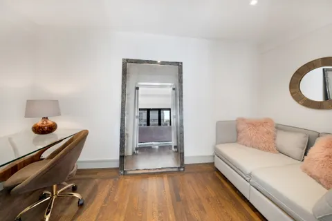 a living room with a couch and a wooden floor