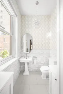 a bathroom with a toilet sink and mirror