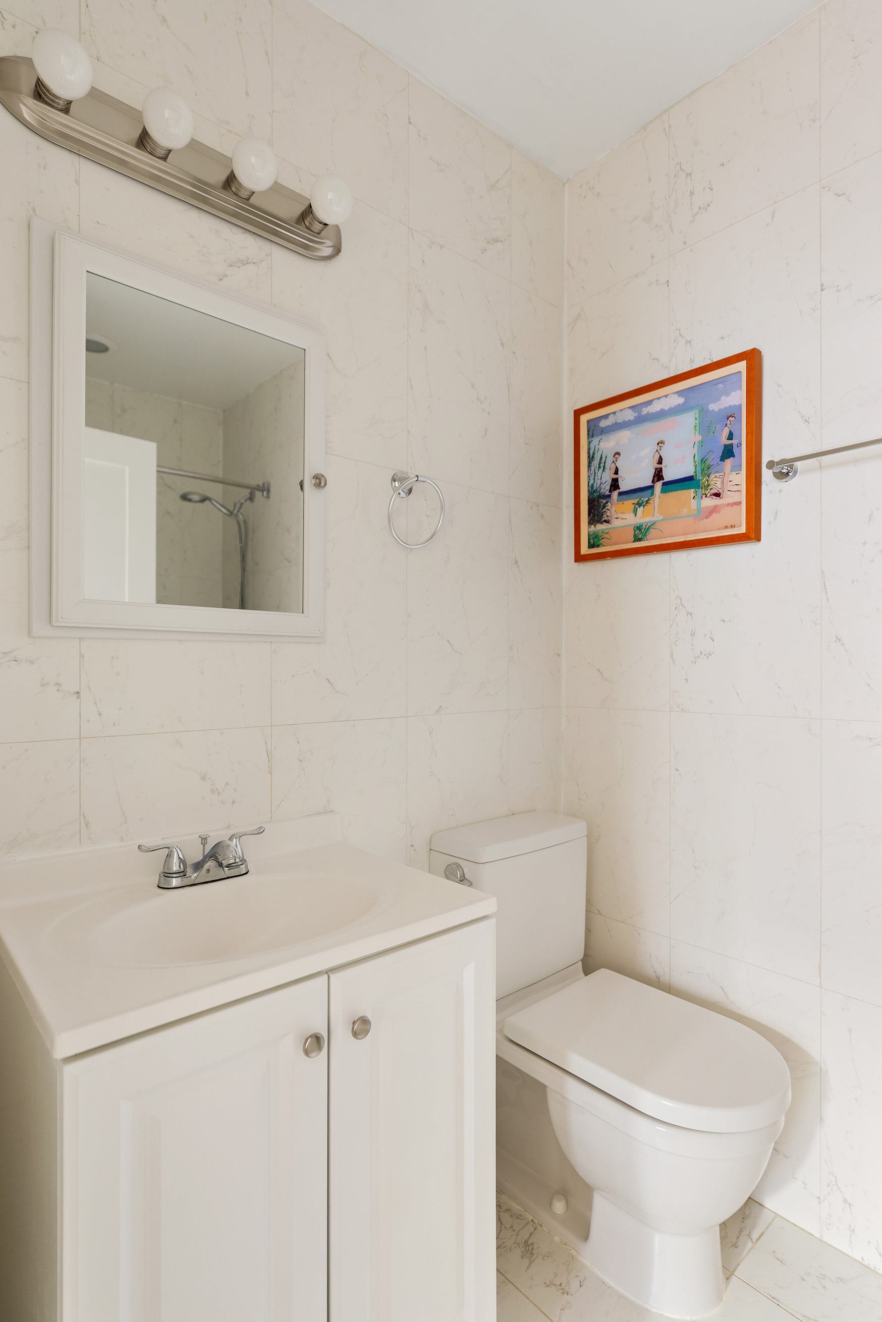 555 Lenox Avenue, Unit 3C Manhattan, NY 10030 - Photo 5 of 7 a bathroom with a toilet sink and mirror